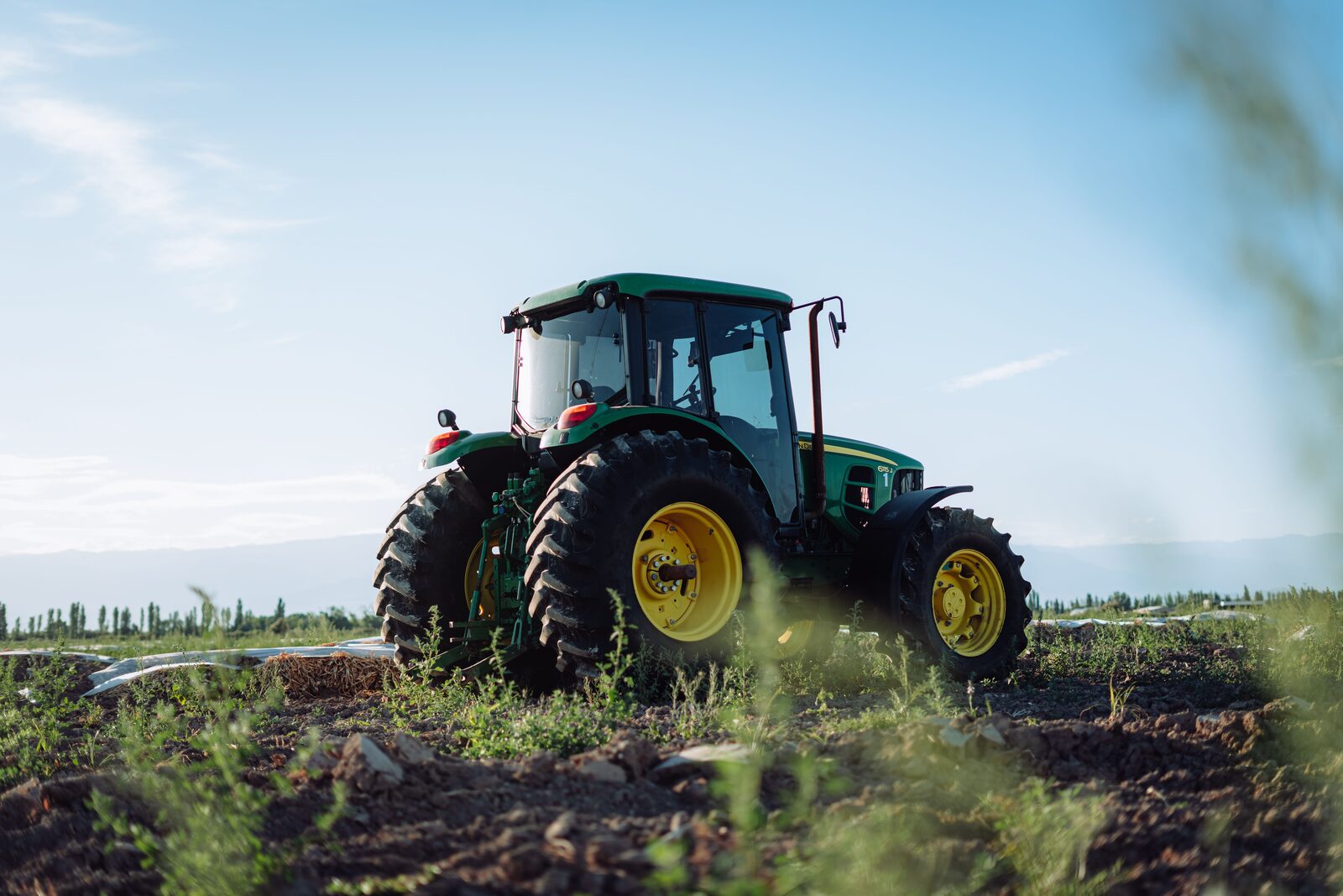 Agricultural tractor working in a crop field