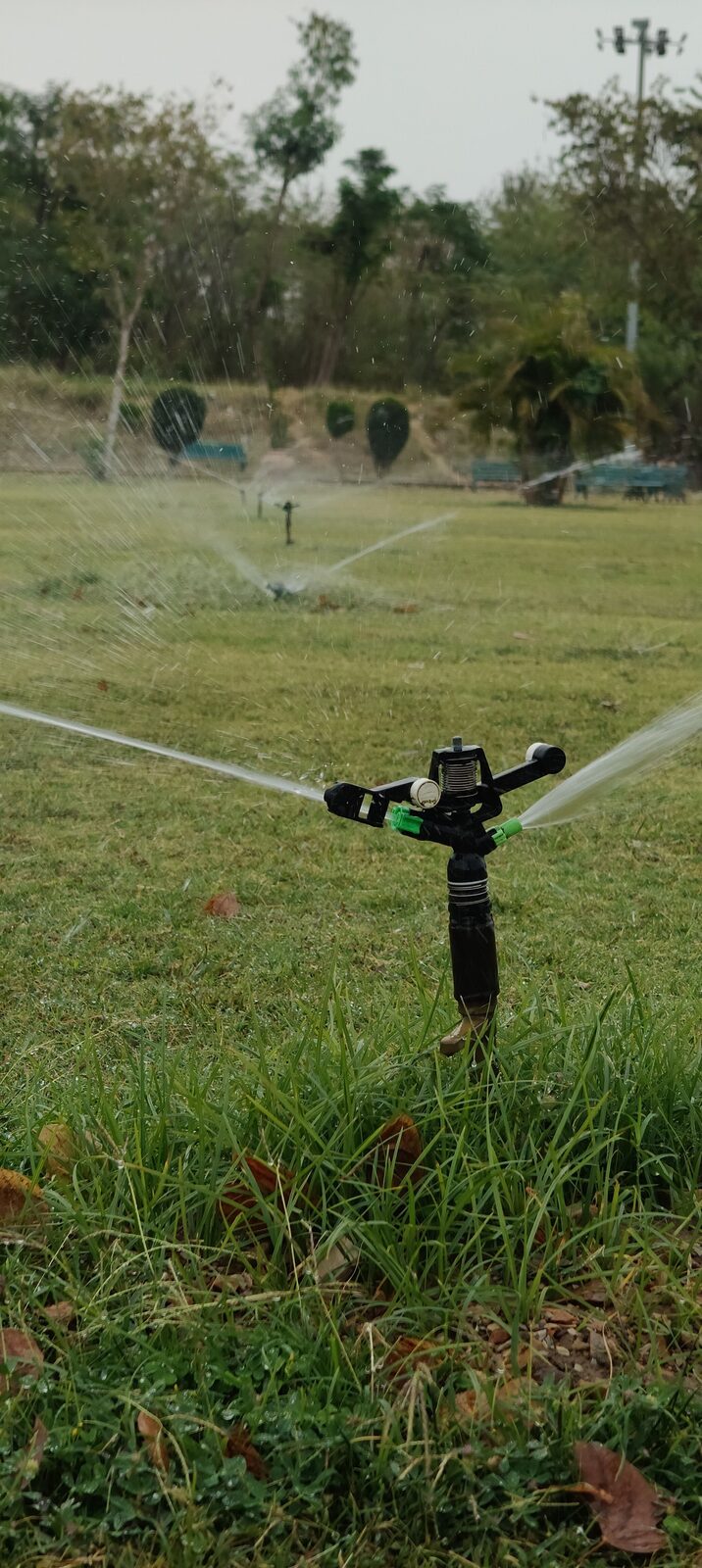 Agricultural sprinkler irrigation system watering a field